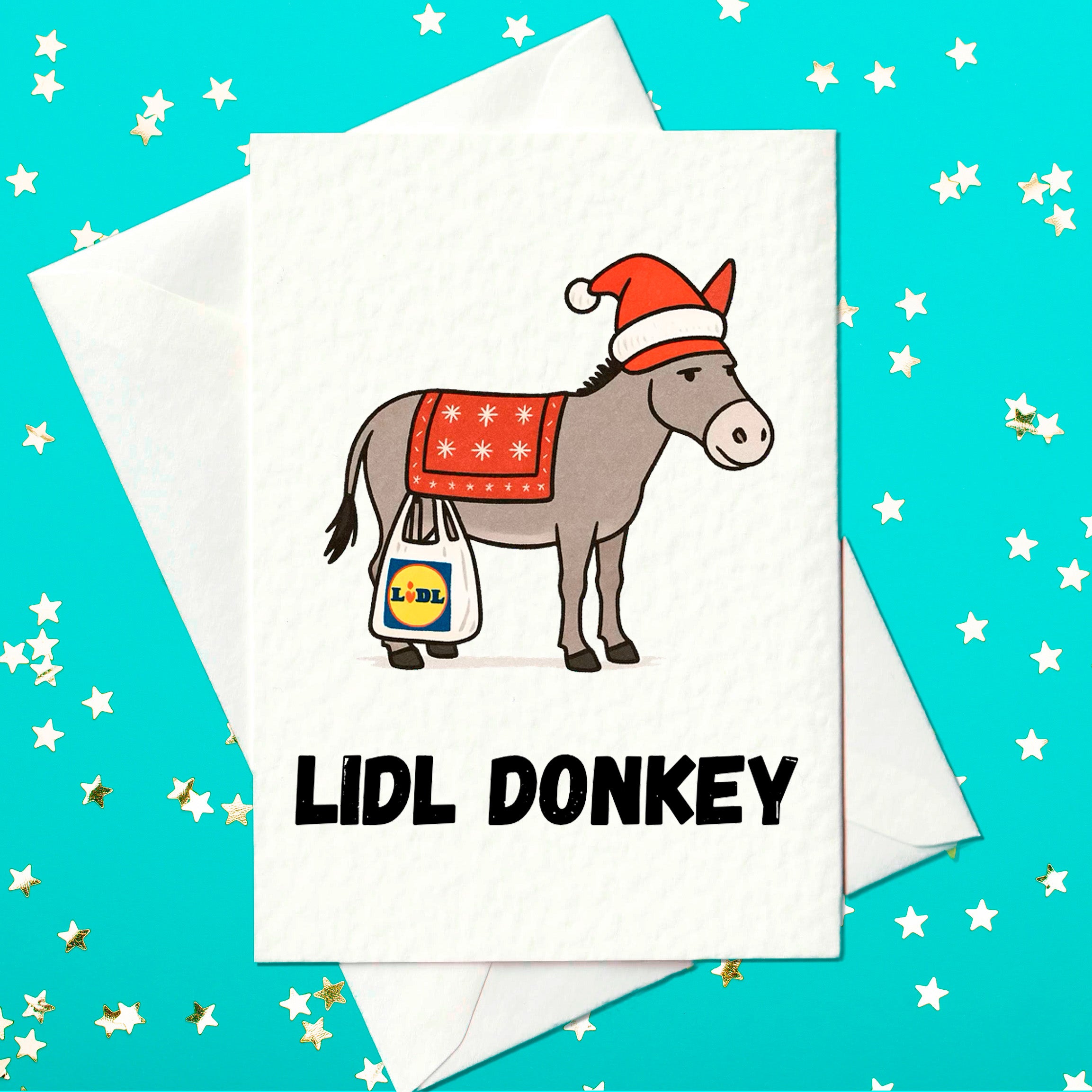 Funny Christmas card featuring a donkey in a Santa hat with a red festive blanket, carrying a Lidl shopping bag, with the pun “Lidl Donkey” printed below.