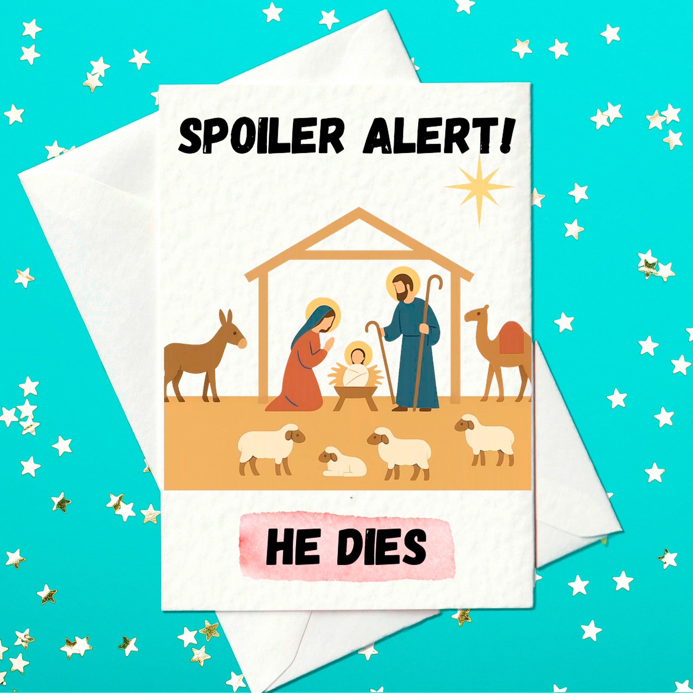 Funny Christmas card showing a nativity scene with Mary, Joseph, baby Jesus, animals and a star, with the text “Spoiler Alert! He Dies” in bold letters.