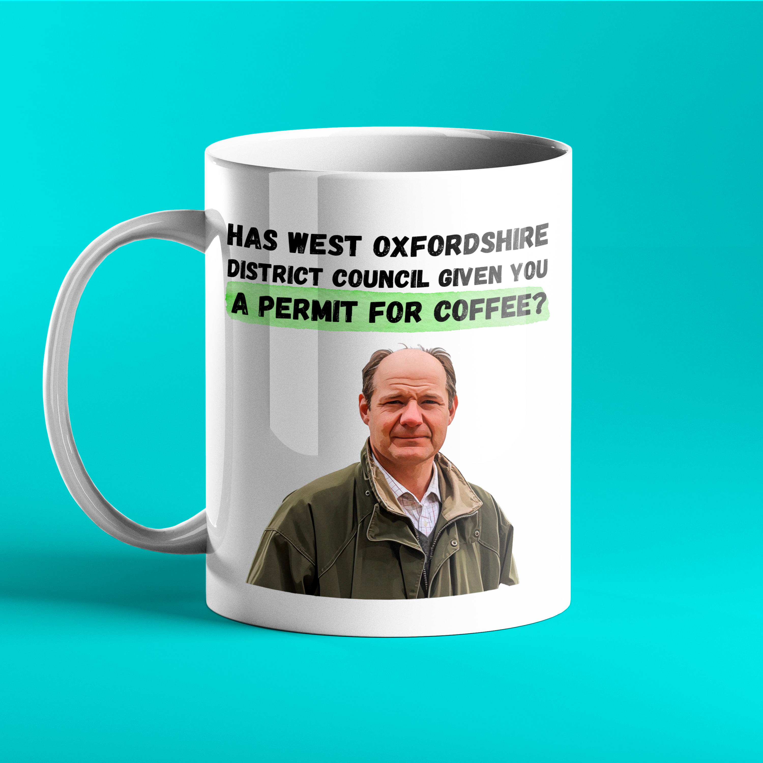 White ceramic mug featuring a photo of Charlie Ireland from Clarkson’s Farm and the quote: “Has West Oxfordshire District Council given you a permit for coffee?” in bold black and green text. Displayed on a turquoise background.
